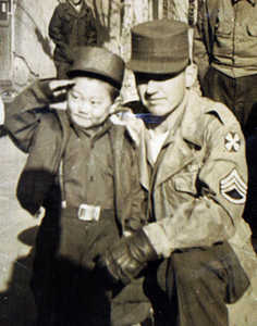 The two pose for a picture during the Korean War. Pete Smith was adopted by another soldier, John Wesley Smith, and brought back to the United States.